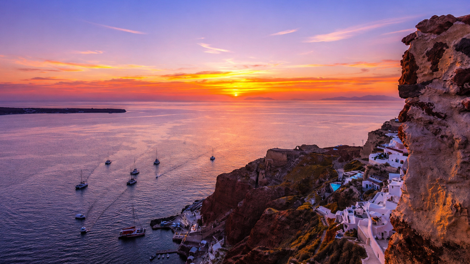 Santorini sunset sea view with cliffside village and boats in the Mediterranean